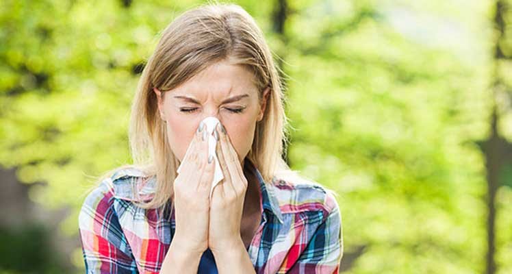 Bild zeigt niesende Frau